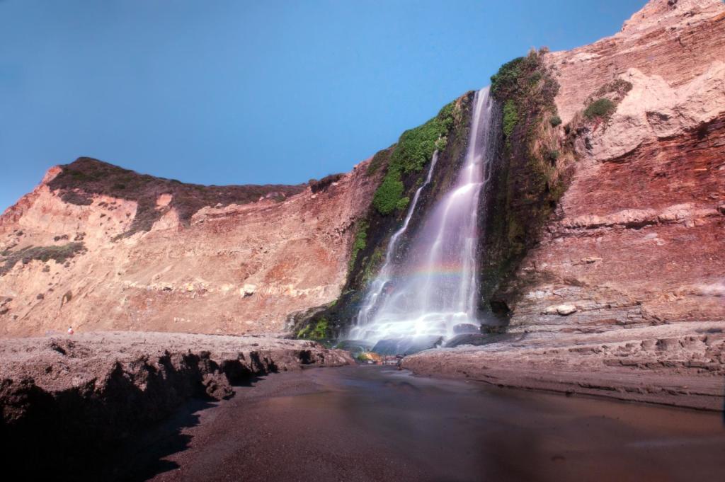 Once down at the beach, you will be treated to a wonderful experience, standing beside a 40 feet waterfall on the ocean.