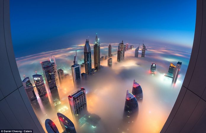 Photographer Daniel Cheong captured this eerie shot of Dubai's skyline as the fog is lit up in green, red and orange from the buildings below