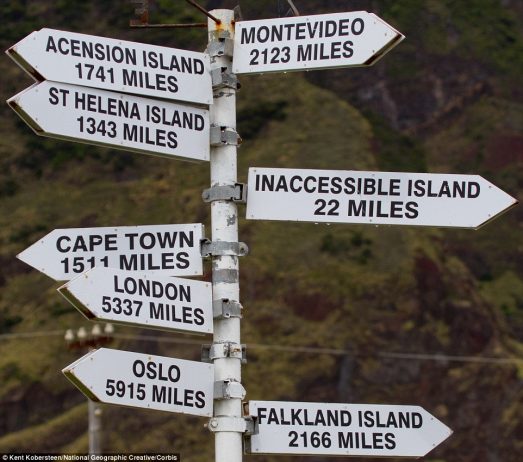 A sign shows the remarkable lengths one must go to get to Tristan, including 5,337 miles to London