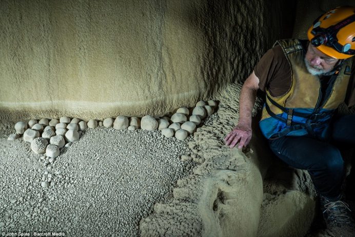 American cave explorer Dave Pierce marvels at giant cave pearls which grow like pearls in an oyster with concentric layers of calcite slowly building up year after year