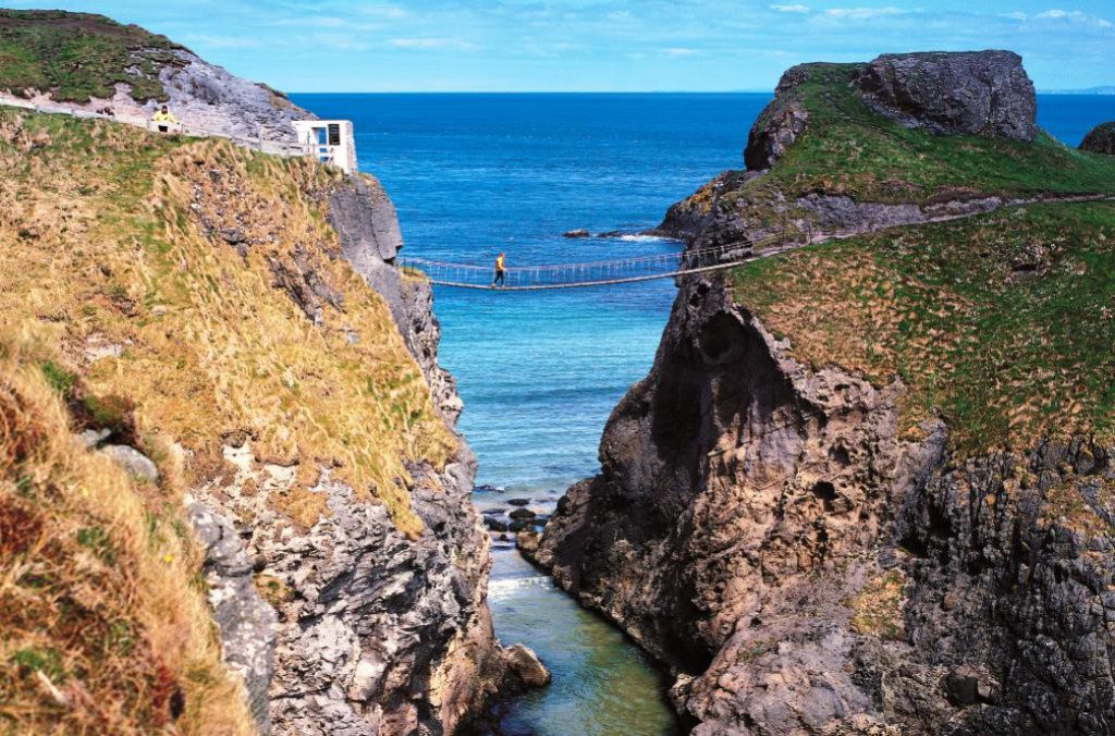 Carrick-a-Rede Rope Bridge is a rope suspension bridge near, Ballintoy, County Antrim, Northern Ireland. The bridge links the mainland to the tiny Carrick Island. Salmon fishermen have been erecting bridges to the island for over 300 years. The current bridge, tested up to 10 tonnes, was built with the help of local climbers and abseilers in 2000. The bridge is owned and maintained by the National Trust, spans 20 metres and is 30 metres above the rocks below