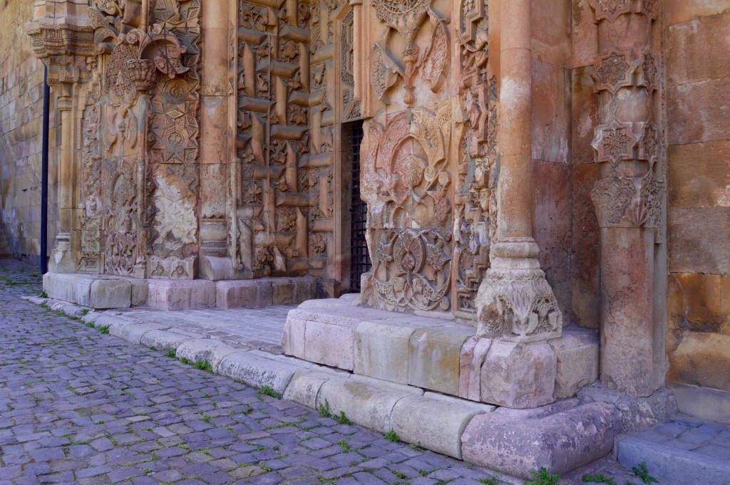 The stone carving is the same quality as the main mosque portal but is less dense and appears, in certain places, to be unfinished.