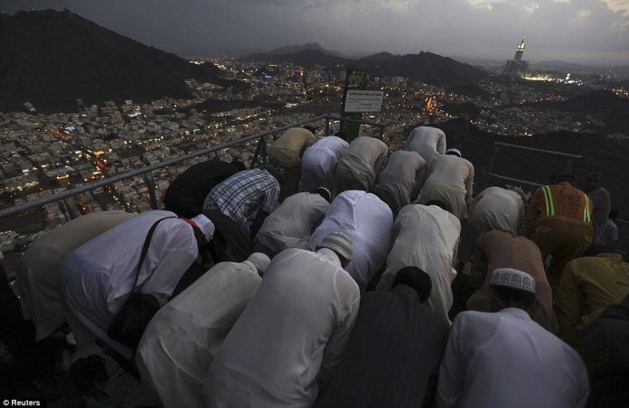 Muslim pilgrims pray at the top of Mount Noor.