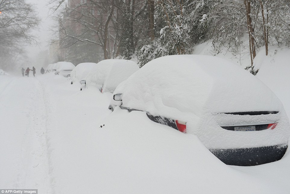 Cars were nearly buried under huge snow drifts in Washington D.C. on Saturday as record breaking snowfall came to the eastern U.S.