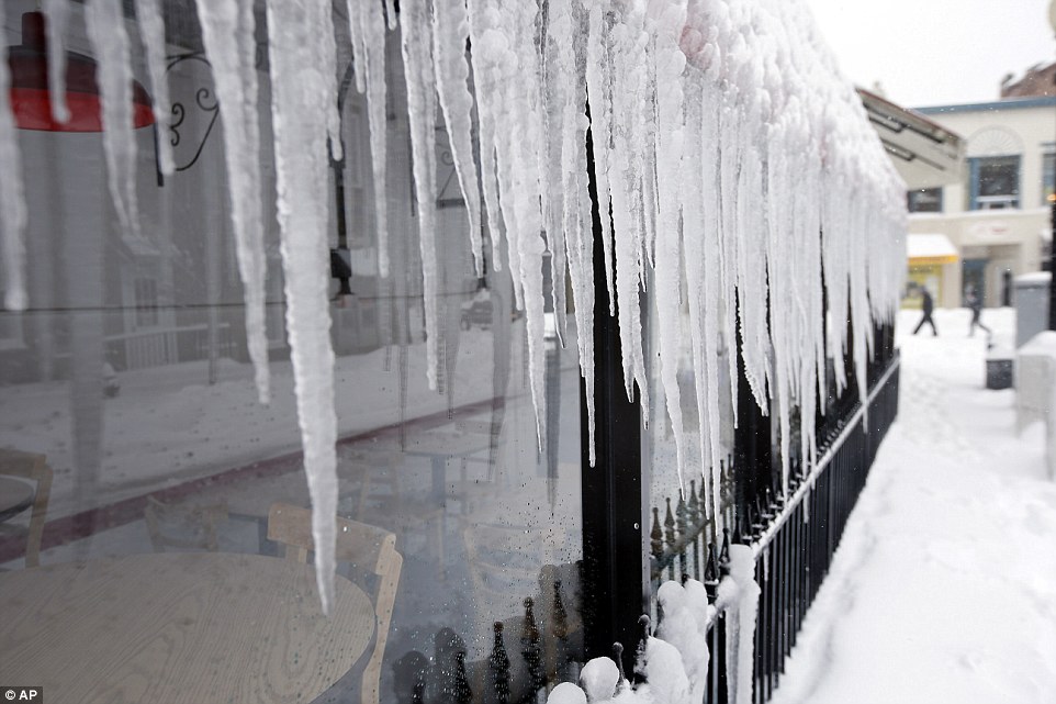 Icicles hang from the awning out the front of a store front in Georgetown, Washington, where up to three feet of snow was reported on Saturday