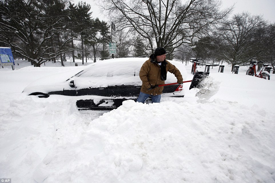 Jared Meyer of Chattanooga, Tenn., digs out his car from the snow, Saturday, January 23, 2016 in Arlington, Virginia