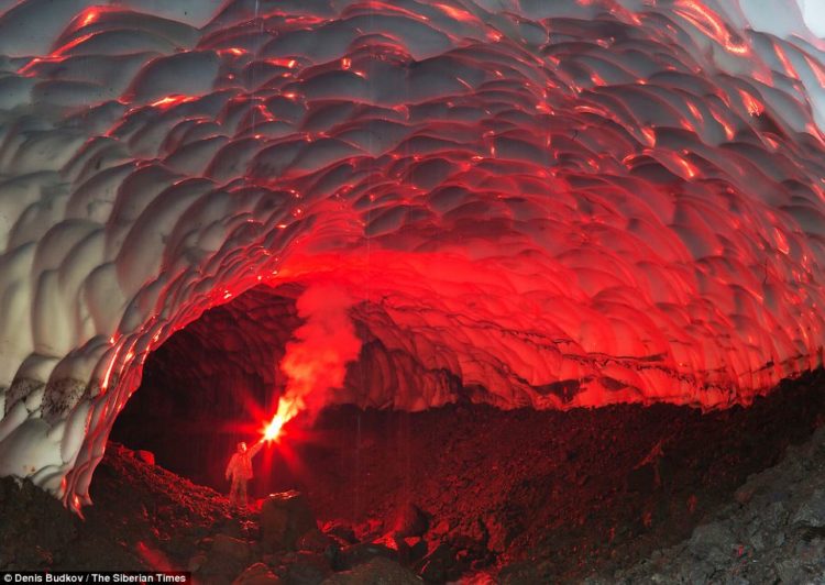 The expedition members lit flares in the cave to highlight the undulating erosion caused by the warm water as it flows through