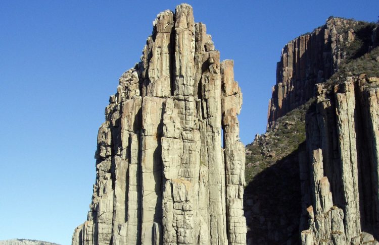 Dolerites are created when molten rocks pushed up from the deep underbelly of the earth cools rapidly and crystallize to form trifling visible crystals in the rock.