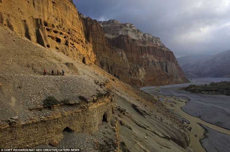Climbers and scientists follow a trail above the Kali Gandaki River
