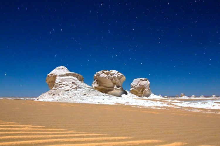 . The limestone bases had been worn away by the mixture of wind and sand that had blown by them at high speeds for thousands of years.