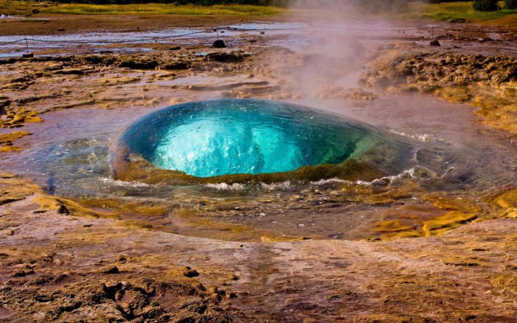 Silica resolves again and is deposited when the superheated waters boil or cool as pressure and temperature fall, respectively as they rise towards the surface.