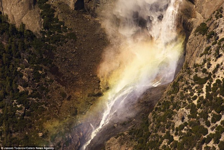 Wispy clouds linger over a waterfall in Yosemite National Park in California in another shot taken from the air