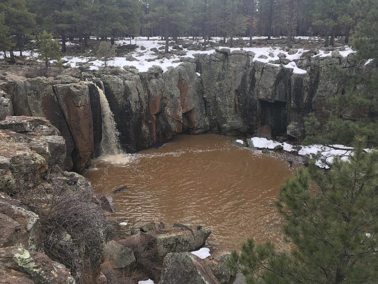 Water flowing in Keyhole Sink, February 2017. Landscape above the canyon walls is also visible, showing the abrupt nature of the geologic sink.