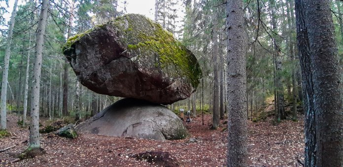 This large strange rock is called Kummakivi located in the dense forest of Ruokolahti near the border of Puumala Finland.