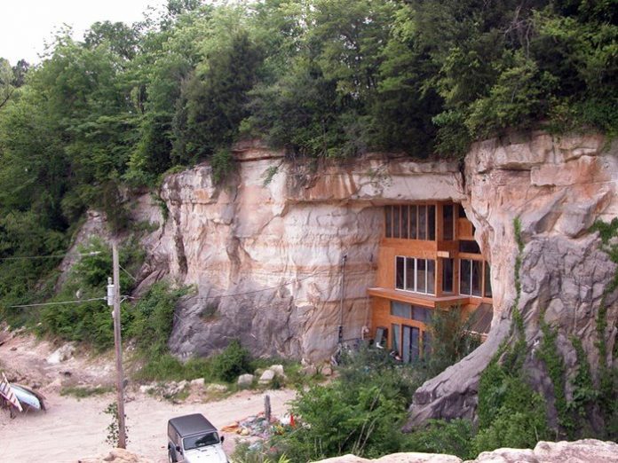 The cave house has three-bedroom, office space, dining and living rooms on the ground floor, kitchen, and bedrooms on a mezzanine.